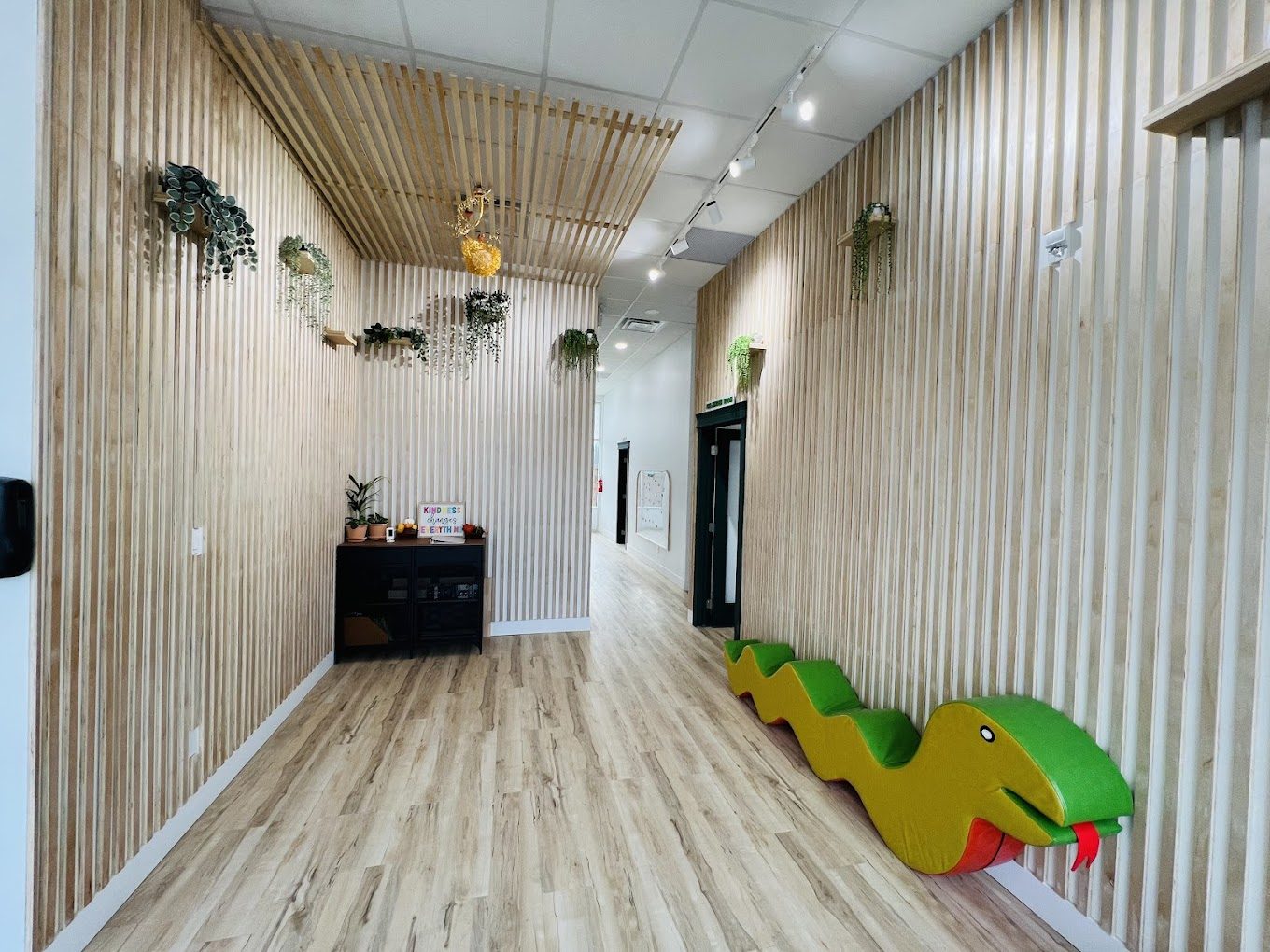 Riverside Daycare interior — natural wood entry and play hallway